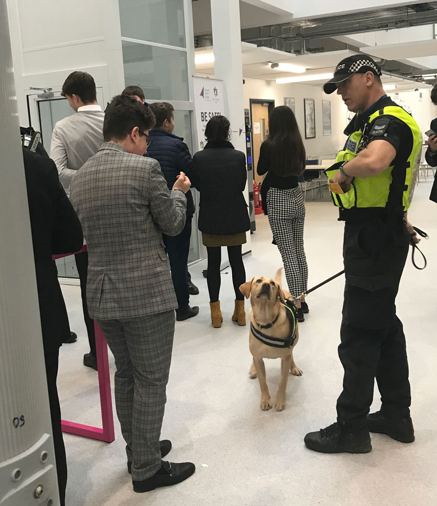 Photo of policeman with sniffer dog